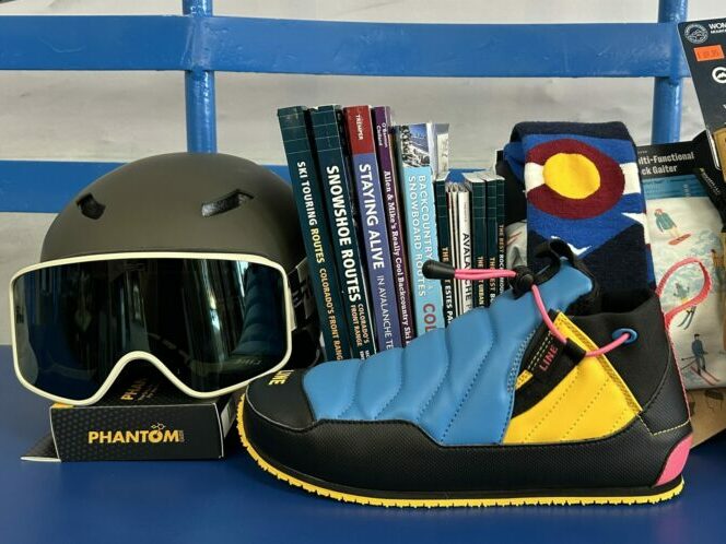 Assortment of ski accessories, books, and clothing.
