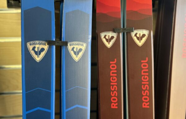 Variety of cross country skis in retail display.